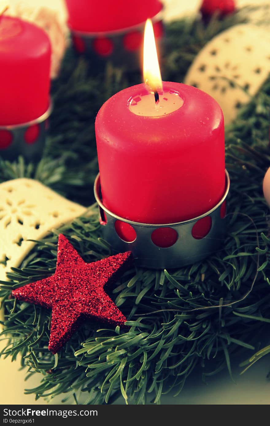 Close up of burning red Christmas candles.