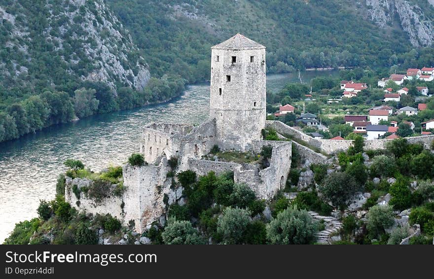 Aerial Picture of Gray Stone Tower Beside River and Town