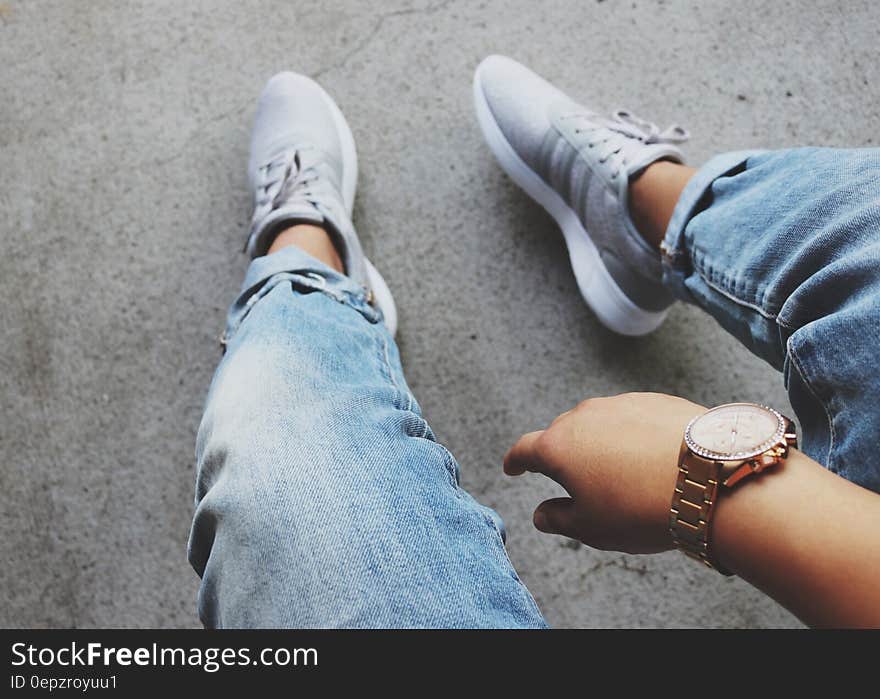 Grey Adidas Sneakers Near Blue Denim Bottoms