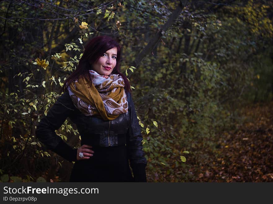 Woman in Black Leather Jacket Beside Trees