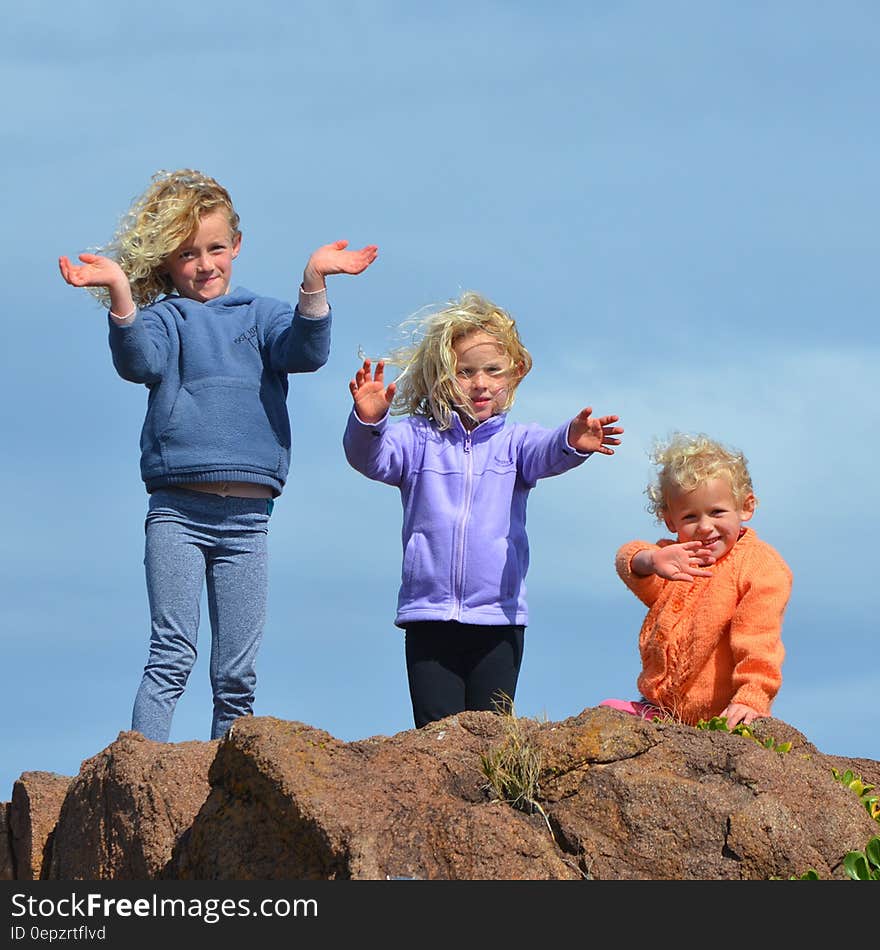 3 Kids Standing on Rock