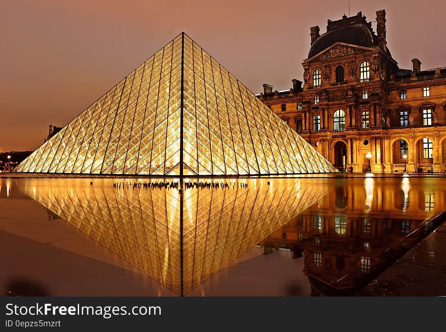 Exterior of glass pyramid at Louvre Museum, Paris, France at night.