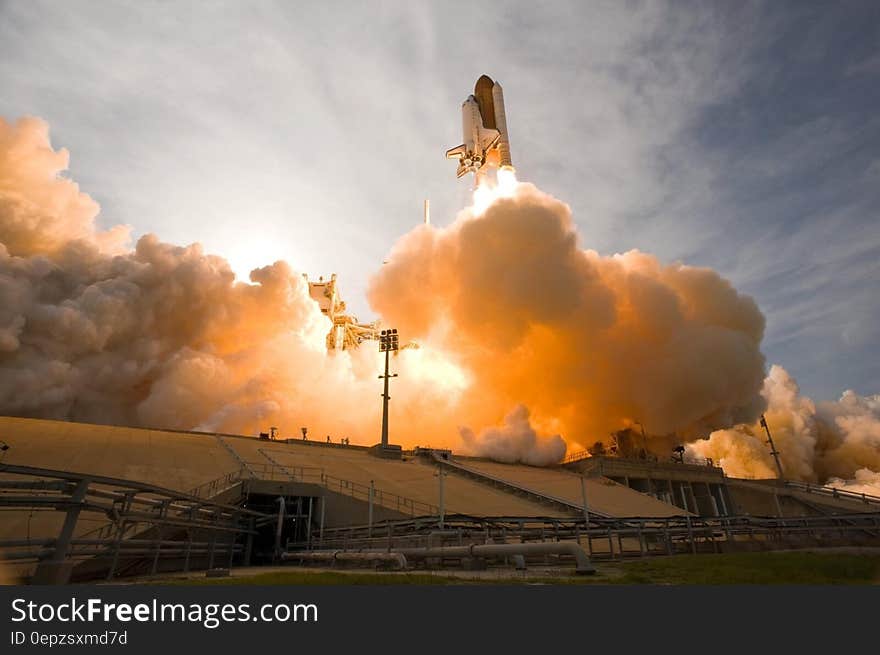 Launch of NASA Space Shuttle in plume of flames and steam. Launch of NASA Space Shuttle in plume of flames and steam.