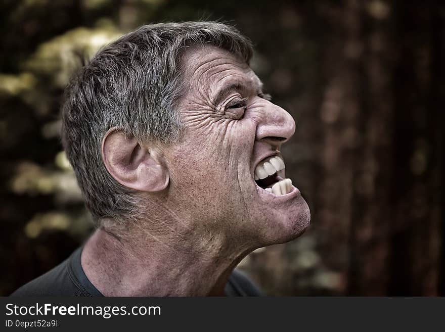 Portrait of man expressing anger outdoors. Portrait of man expressing anger outdoors.