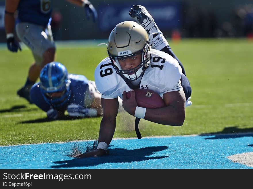 Football Player Diving Towards the Goal