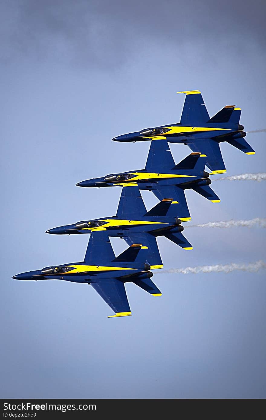 US Air Force Blue Angels stunt planes in formation in blue skies. US Air Force Blue Angels stunt planes in formation in blue skies.