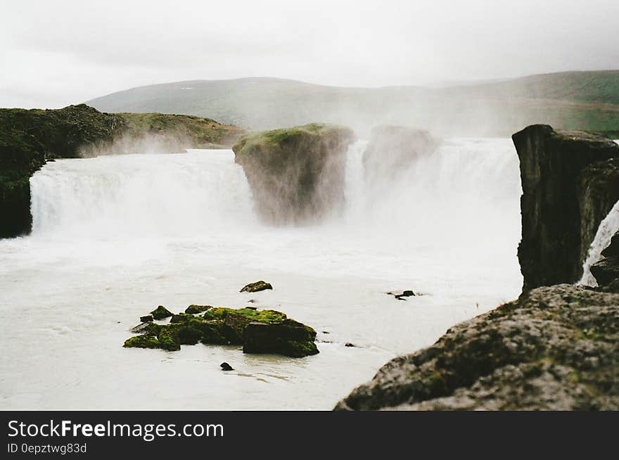 Waterfalls over cliffs in river on sunny day. Waterfalls over cliffs in river on sunny day.