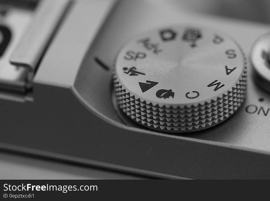 Close up on dial control of camera in black and white. Close up on dial control of camera in black and white.