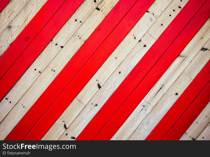 Abstract pattern of red and white boards in geometric stripes.