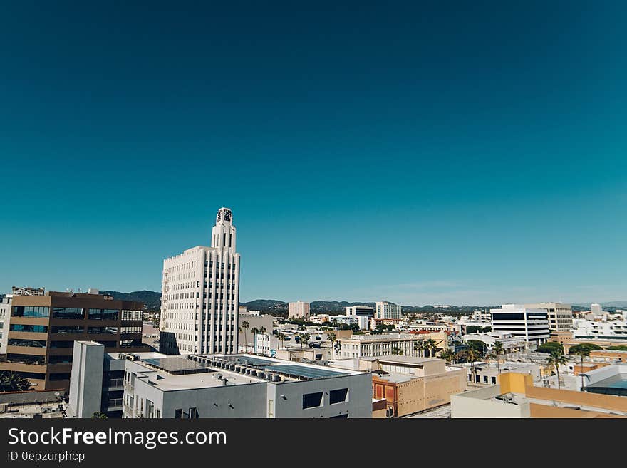 Aerial view over rooftops of Santa Monica, California on sunny day against blue skies.