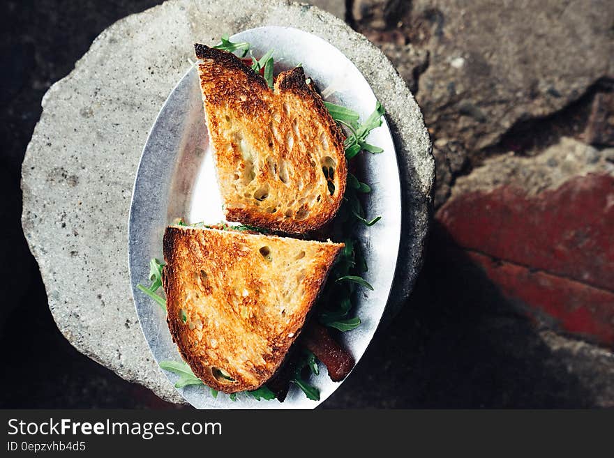 Arugula salad sandwich in toasted bread viewed from above.