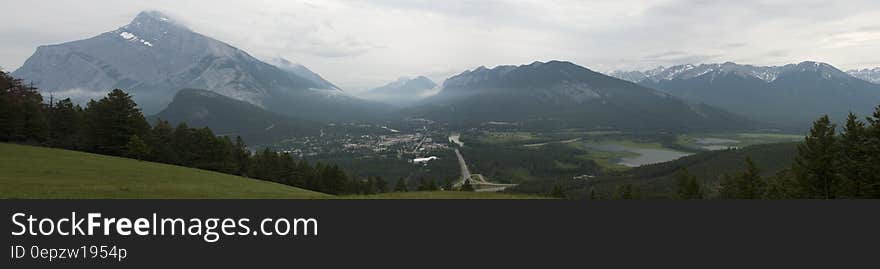 Mountains in the Background and Green Meadows during Daytime