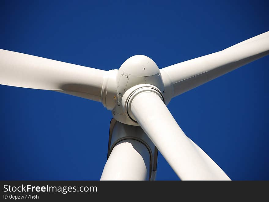 Low Angle Photo of White Wind Turbine Under Deep Blue Sky