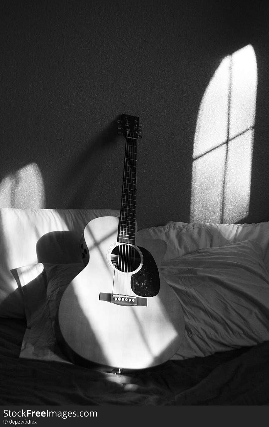 White Acoustic Guitar on Grey and White Textile