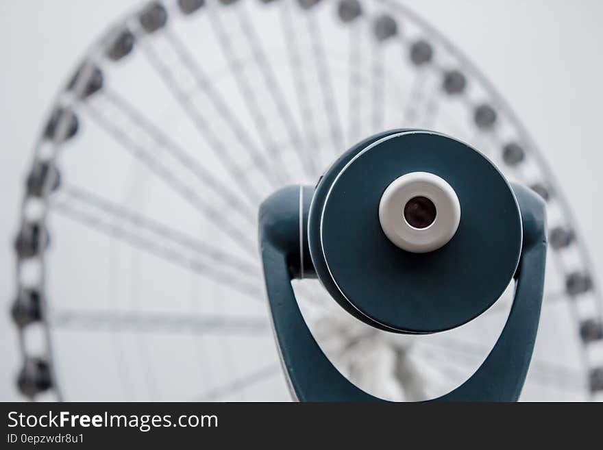 Binocular pointing at ferris wheel in background. Binocular pointing at ferris wheel in background.