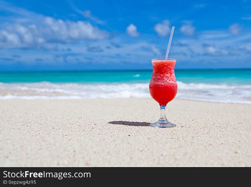 Red Slush Drink in Glass on Beach