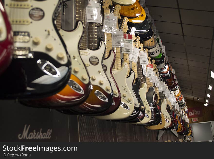 Electric Guitar Hanging Near Wall