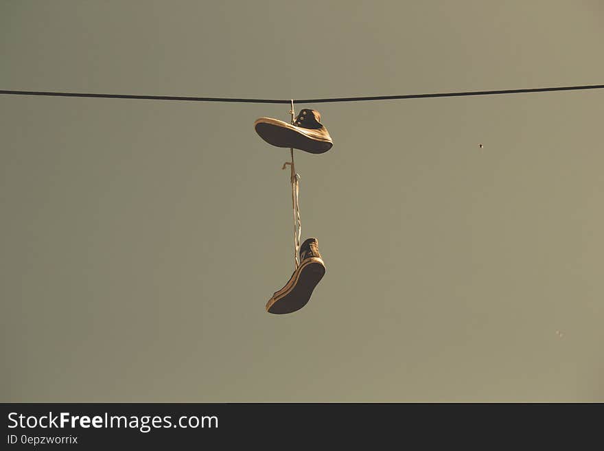 White Black High Top Shoes Hanging on Electric Line