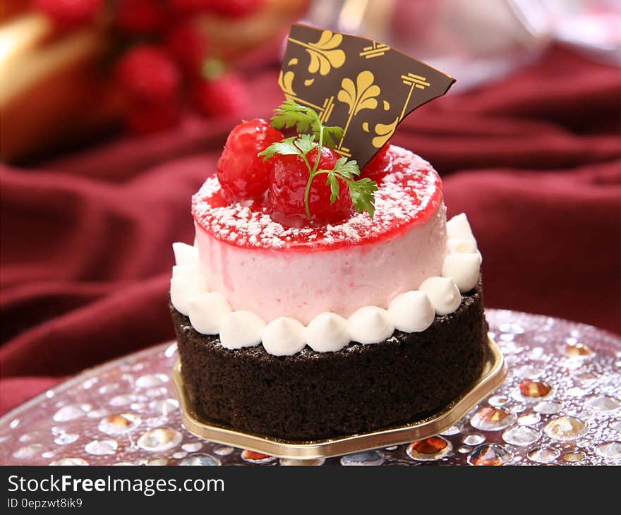 Chocolate Cake With White Icing and Strawberry on Top With Chocolate