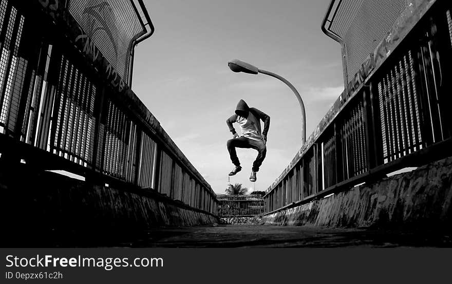 Man Jumping on Air Wearing Gray Hoodie