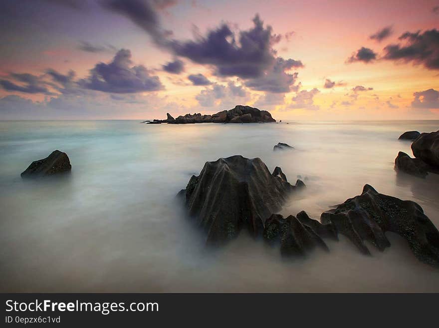 Time Lapse Photography of High Rise Mountain Covered With Clouds