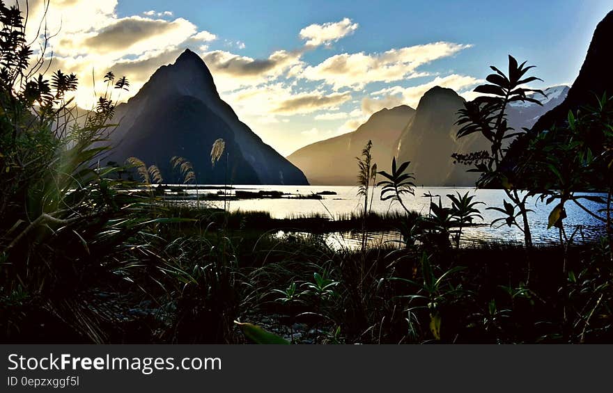 Mountains on Sea during Day Time