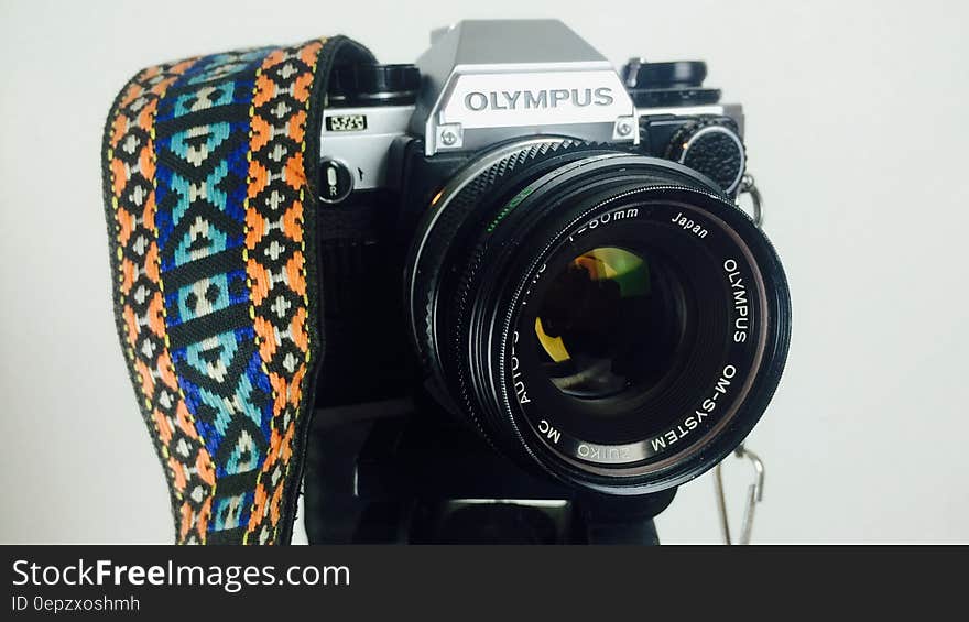 Black and Gray Olympus Dslr Camera White Orange Blue and White Strap