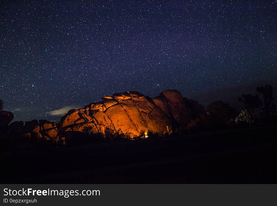 Camp Fire Beside Cave during Nighttime