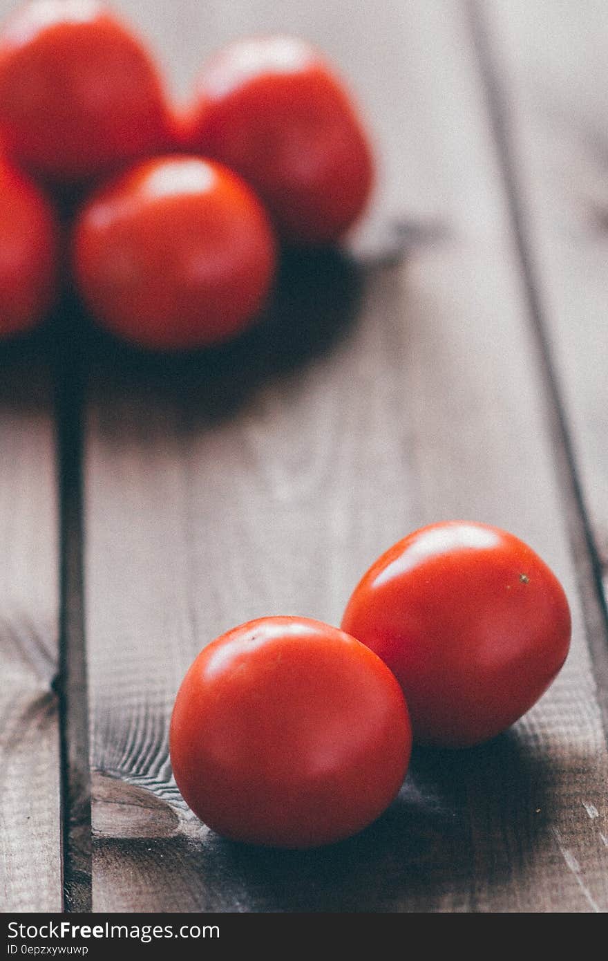 Cherry tomatoes on wooden background.