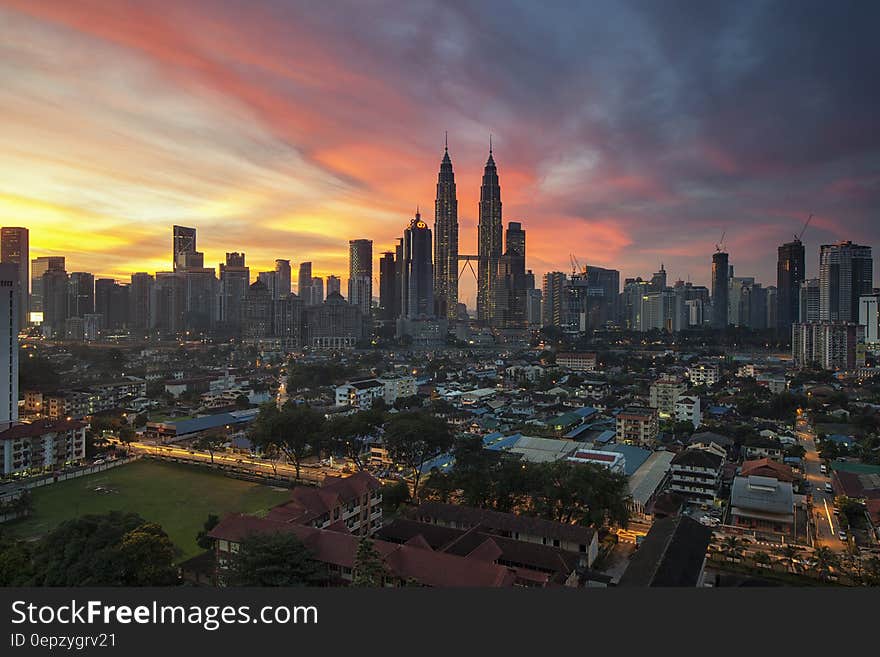 City Buildings Under Orange Sunset