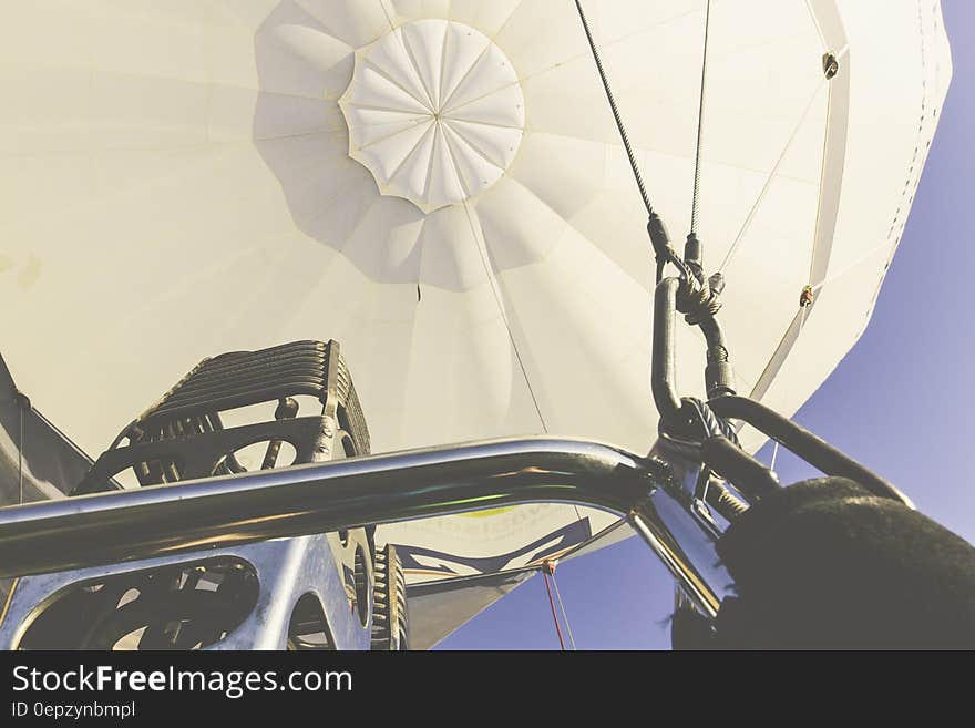 Silver Steel Bar Near Steel Blow Torch on White Hot Air Balloon during Daytime