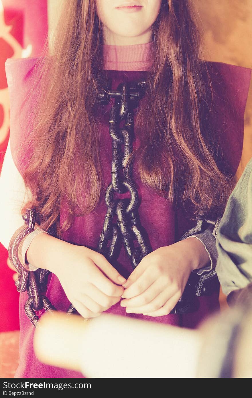 Woman in Maroon Shirt With Black Chain on Her Body