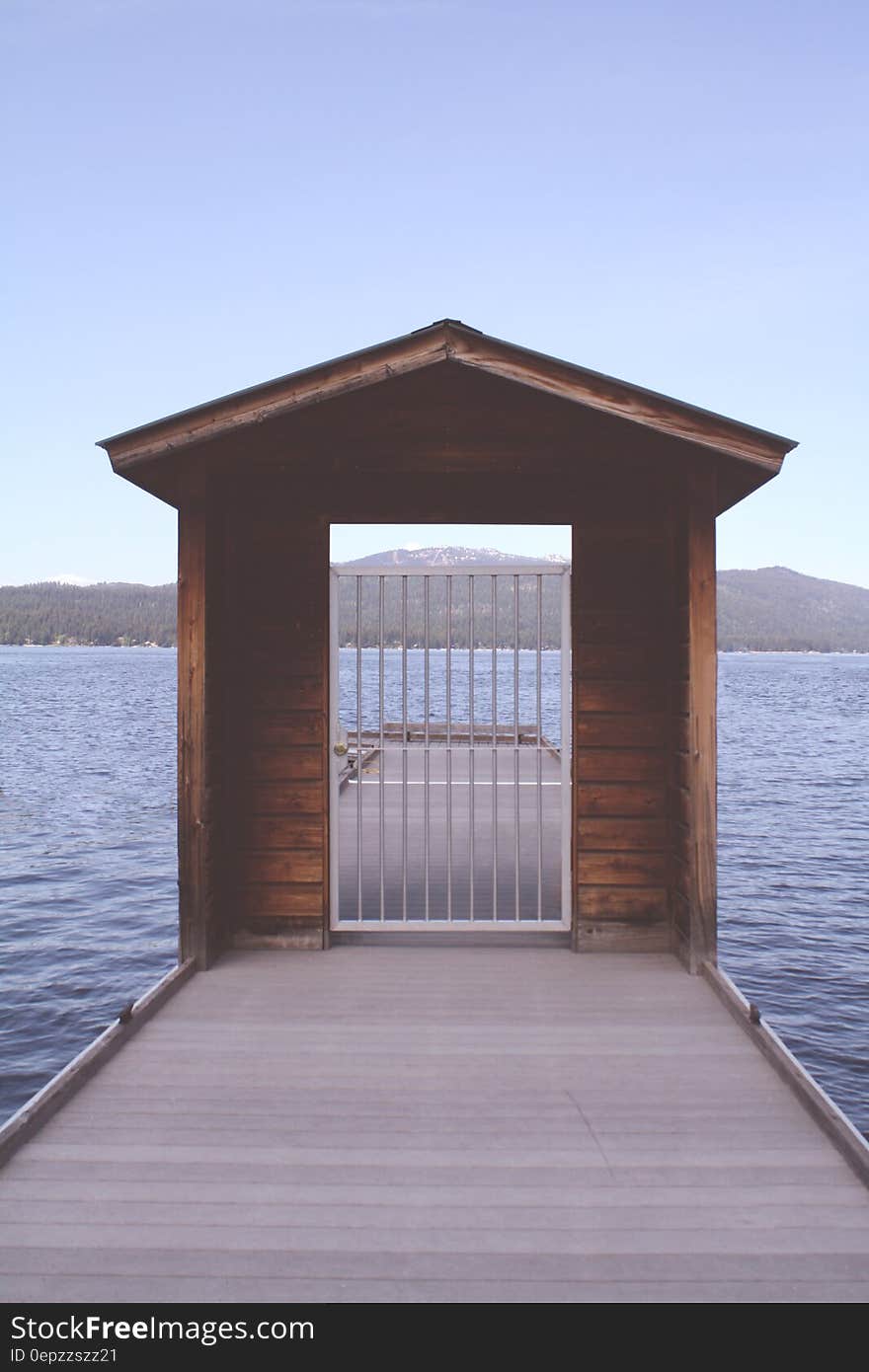 Brown Wooden Dock With White Metal Fence