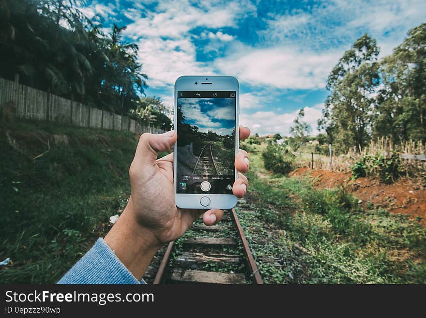 Person Holding Silver Iphone 6 Taking Photo