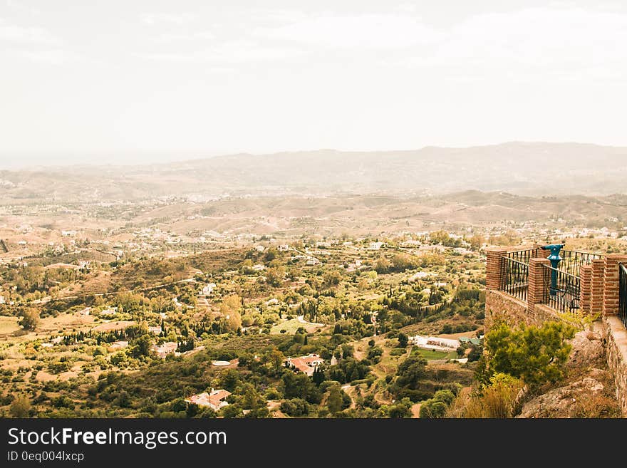 Arid landscape viewed from city walls with mountains in background.