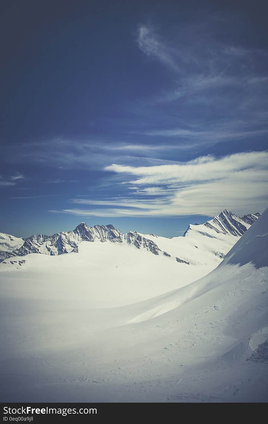 Mountain Surrounded by Snow Under Blue Sky