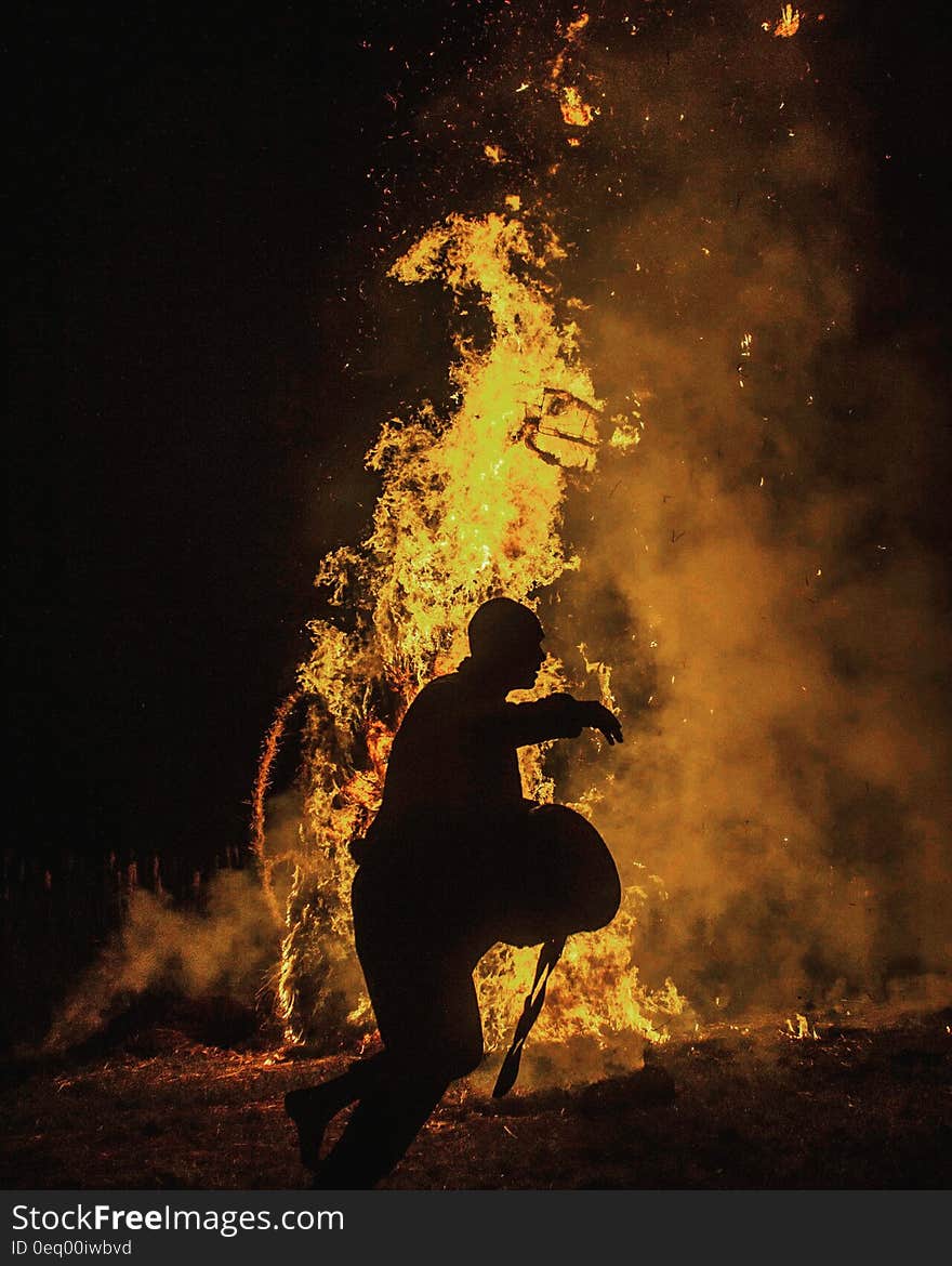 Person Silhouette Near the Fire