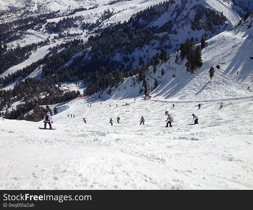 Person Riding on Snowboard on the Snow during Daytime