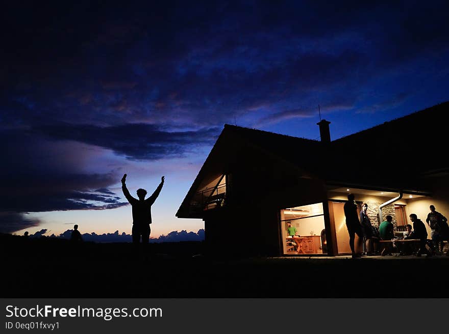 Silhoutte of Person Standing during Night Time