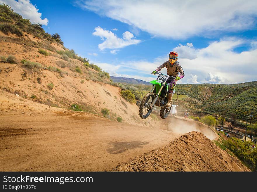 Human Riding Motor and Jumped Under Blue Sky during Daytime