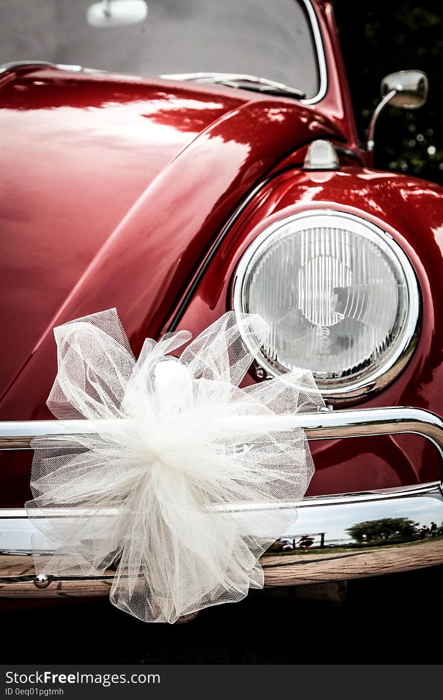 Vintage red VW Beetle with white bow for wedding. Vintage red VW Beetle with white bow for wedding.