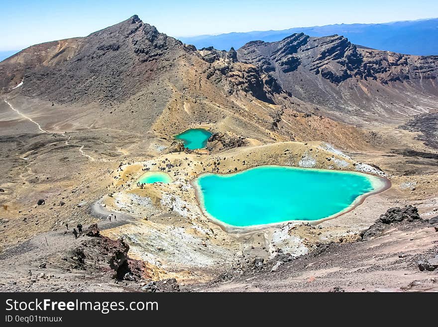 Bodies of Water Surrounding Mountain during Daytime