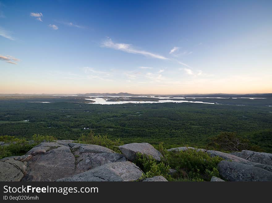 Grey Rocks Cliff Overlooking Marsh during Daytime