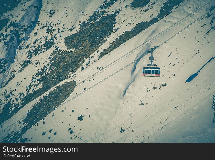 Cable Car Above Snow Covered Mountain