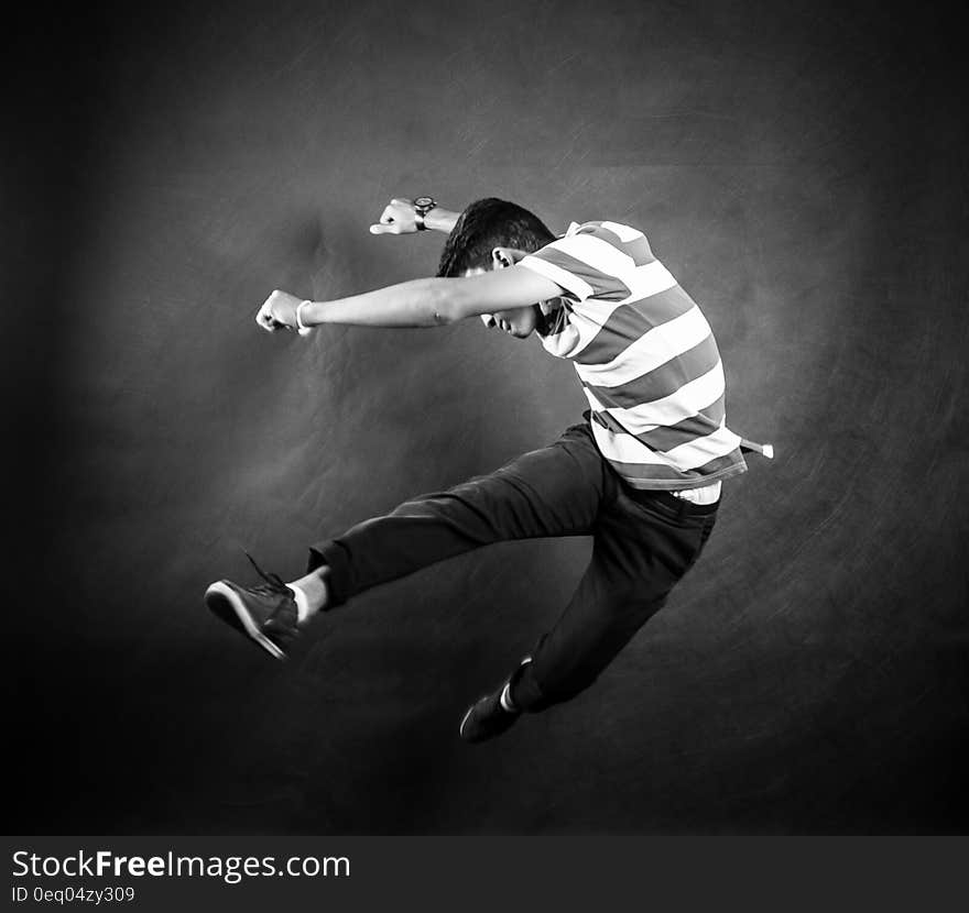 Grayscale Photograph of Man Wearing White and Black Stripe Crew Neck T Shirt