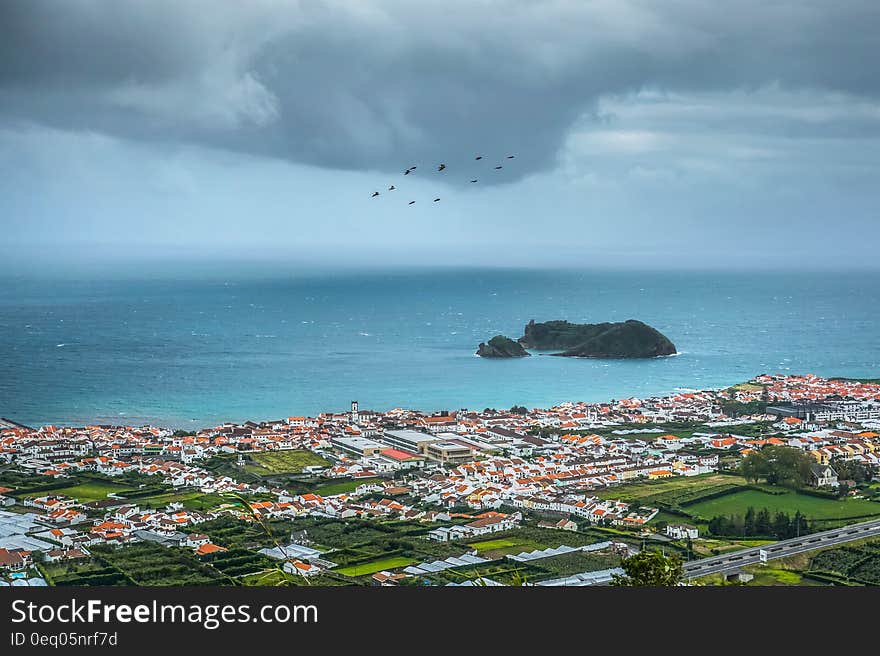 Coastal city on waterfront in Azores, Portugal with overcast skies. Coastal city on waterfront in Azores, Portugal with overcast skies.