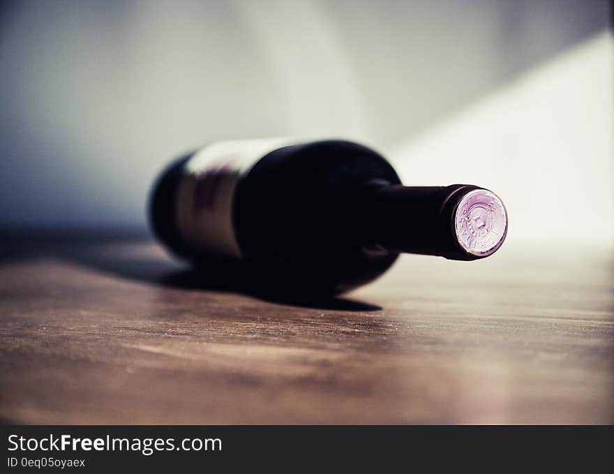 White Labeled Bottle on Brown Wooden Surface