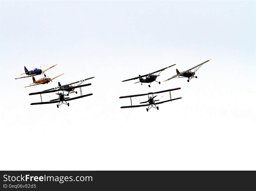 7 Biplane Flying on Air Under Clouds during Daytime