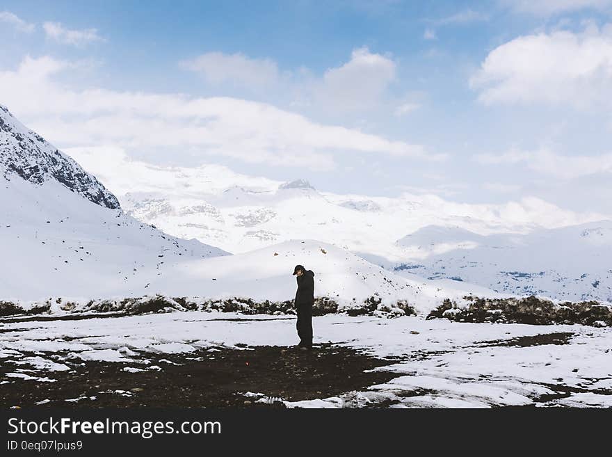 Man in Black Shirt Standing on White Snow Field