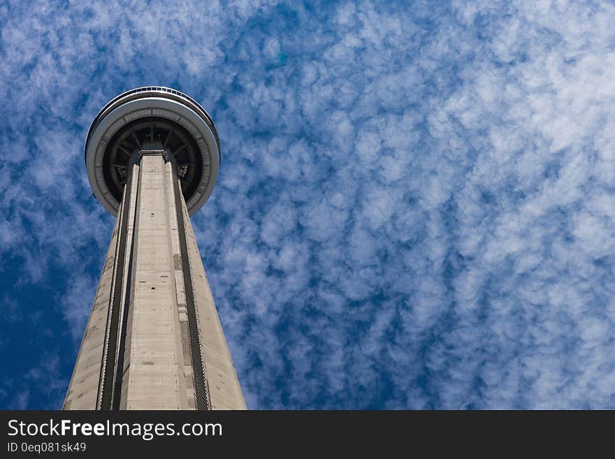 Gray and Black Concrete Tower Under White and Blue Sky